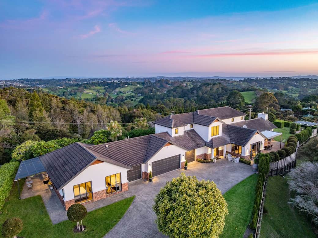 The view from above the driveway of the entire front of the property, including the 2 bedroom self contained unit in front and the 5 bedroom main house.
