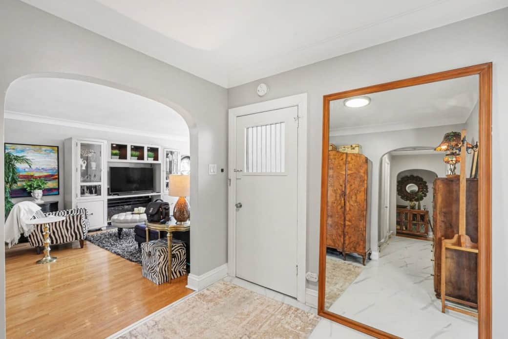 Spacious shared front entryway with secure access and storage