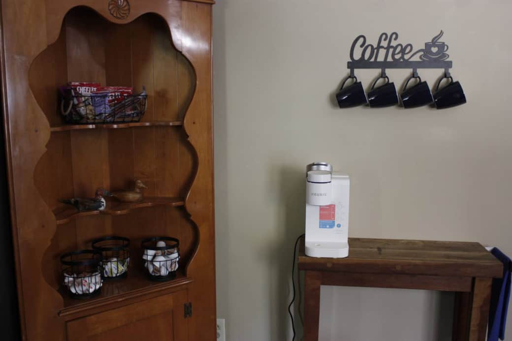 Coffee station with a Keurig, pods, cream and sugar along with those grab and go snacks