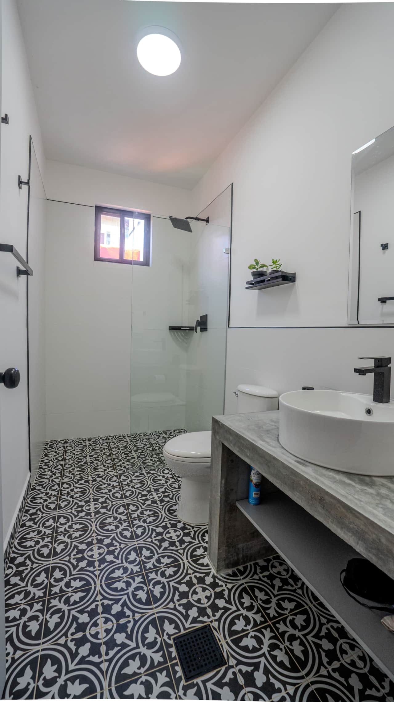 Freshen up at the chic concrete vanity of our sustainable cabin rental in Panama.