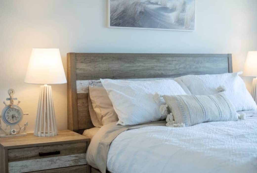 The master bedroom features a queen bed, smart TV, wardrobe and door to the deck. 