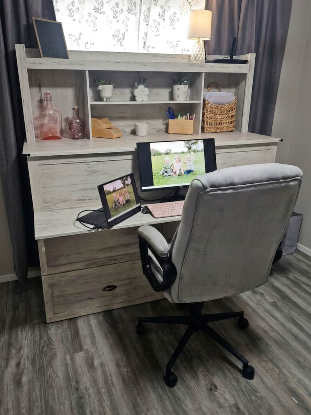 Docking station, monitor, keyboard, mouse and printer located in cabinet to the right of the desk.
