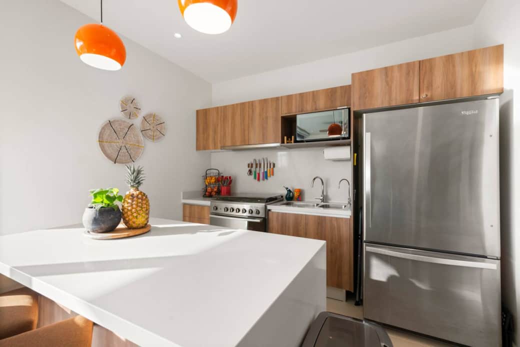 Fully equipped kitchen with filtered drinking water and ice, plus dishwasher, microwave, coffee maker (with coffee), blender, toaster, full-size fridge, stove, and oven—everything you need to make a meal and enjoy it at home.