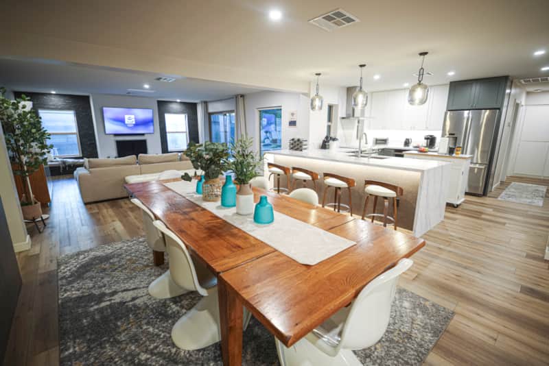 Dining table for eight beside the kitchen and open living spaces.