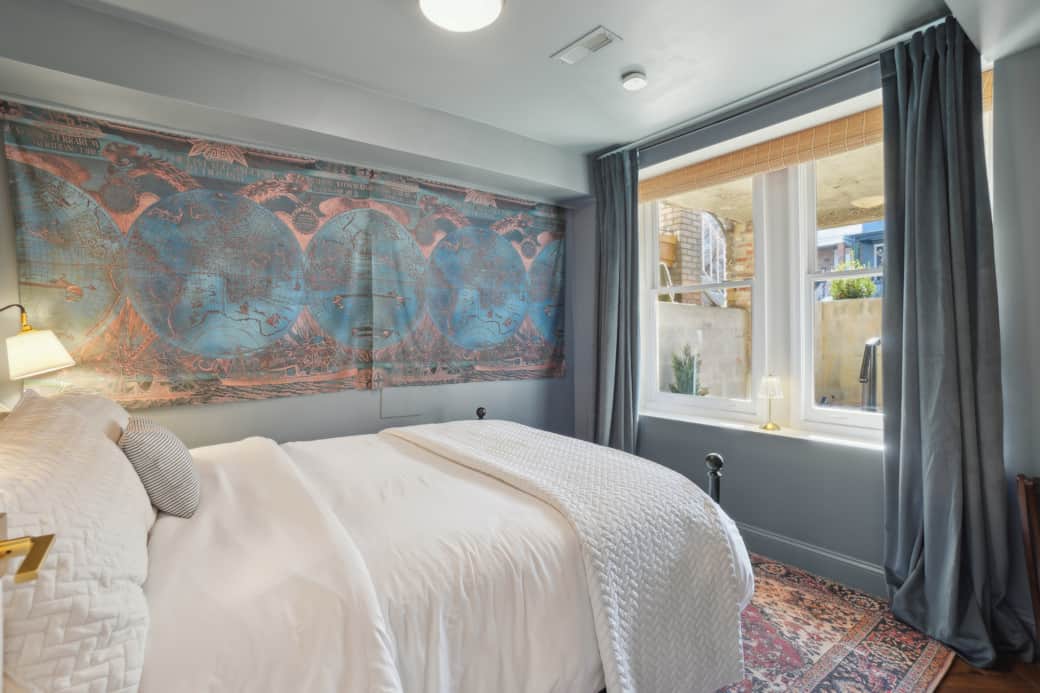 The cozy first bedroom has a queen bed and blackout curtains.
