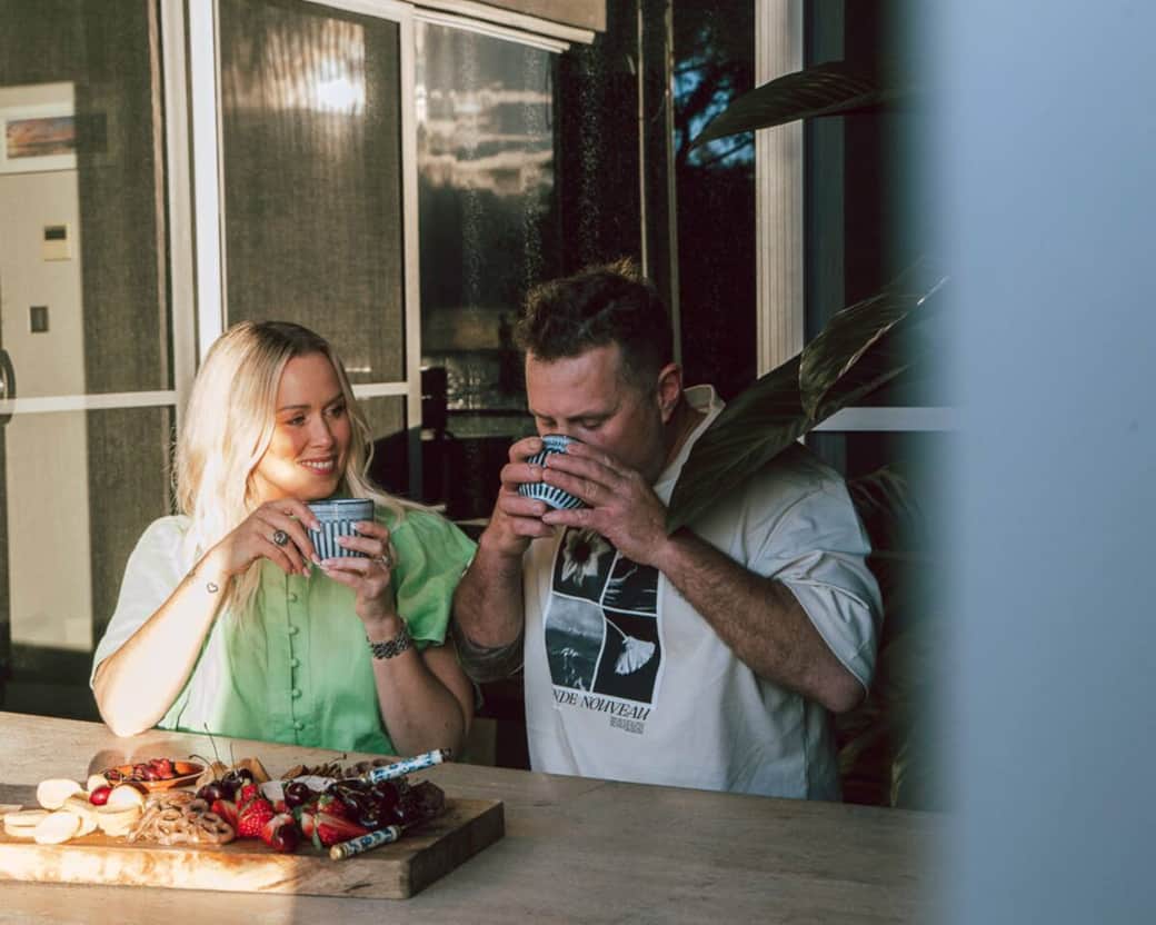 Couple enjoying coffee on balcony