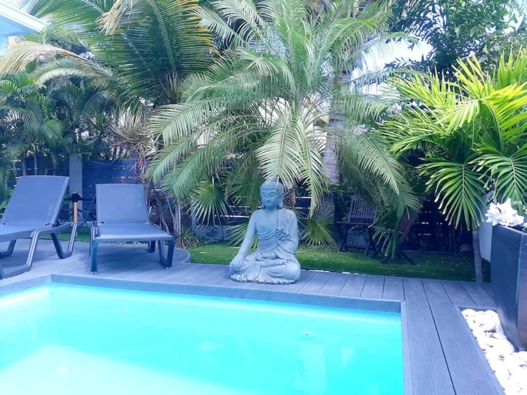 Sun beds around the pool with garden Magnolia