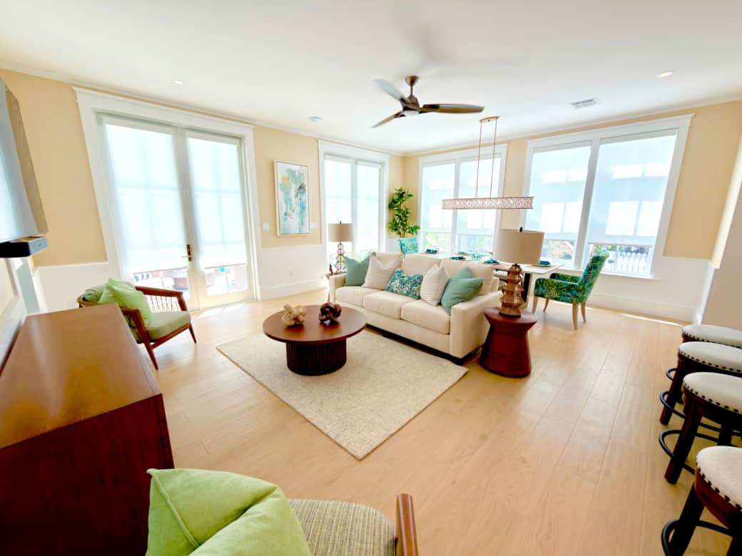 Bright family room with open-concept design, pool access, and relaxed coastal style. Bright family room with open-concept design, pool access, and relaxed coastal style.