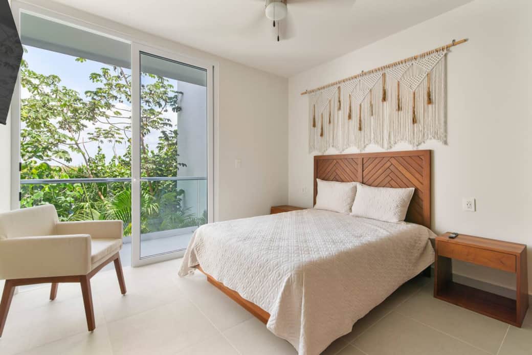 Second bedroom with Smart TV, A/C, fan, and balcony overlooking Akumal jungle.