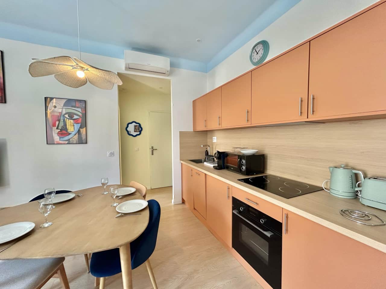kitchen, dining table, microwave, oven, kettle, toaster