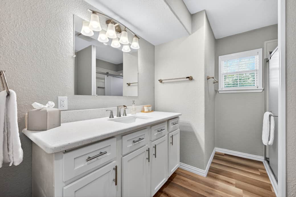 Guest bathroom with vanity and glass shower