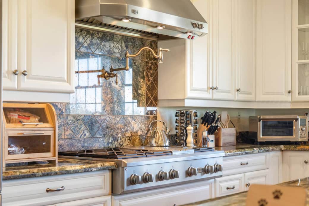 6-burner gas range, griddle, and pot-filler in Chef's kitchen.