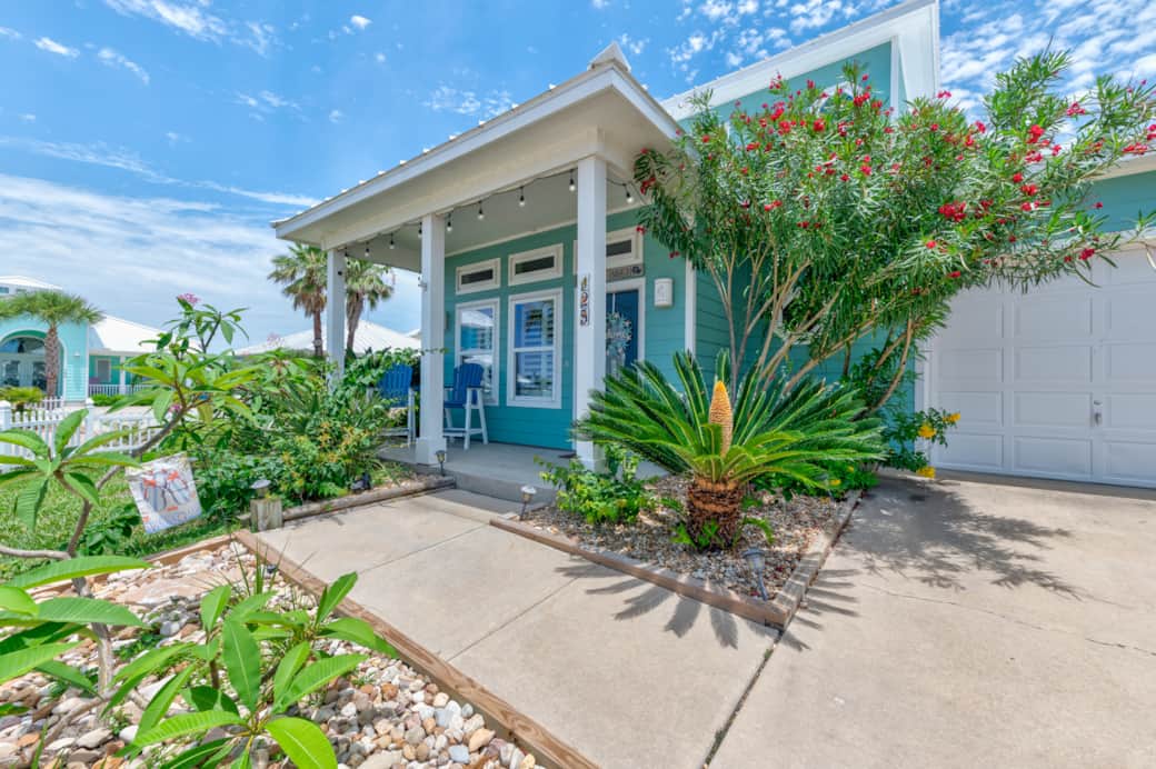 Front of house with patio and beds