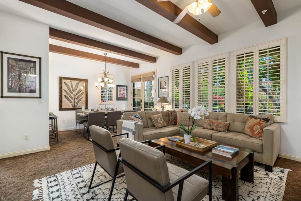 Open-concept living & dining room. This space offers a comfortable sectional sofa & two sleek chairs