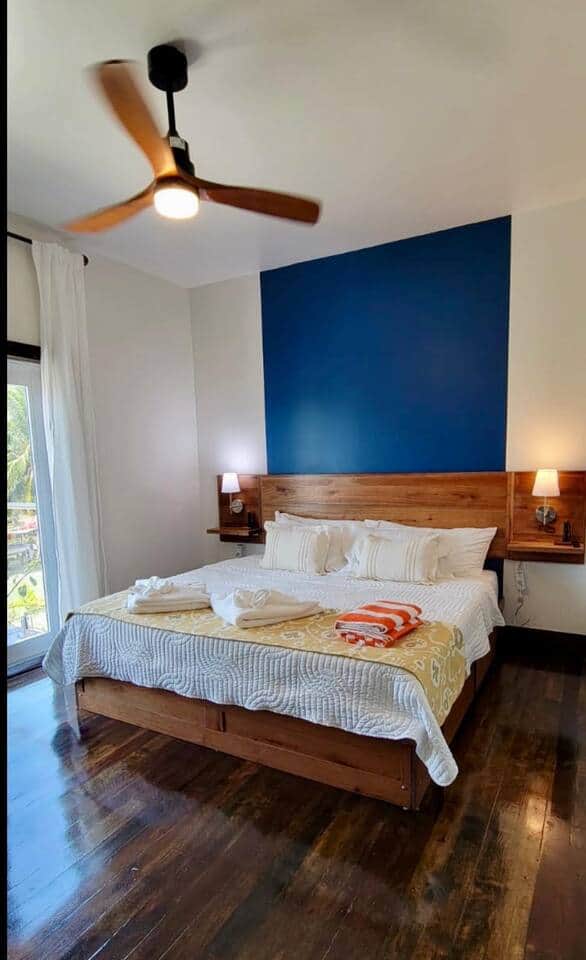 The bedroom features a comfortable king-size bed with an ensuite private bathroom. A glass door opens to a small patio, offering a stunning west-facing ocean view—perfect for enjoying breathtaking sunsets right from your room. The bedroom features a comfortable king-size bed with an ensuite private bathroom. A glass door opens to a small patio, offering a stunning west-facing ocean view—perfect for enjoying breathtaking sunsets right from your room.