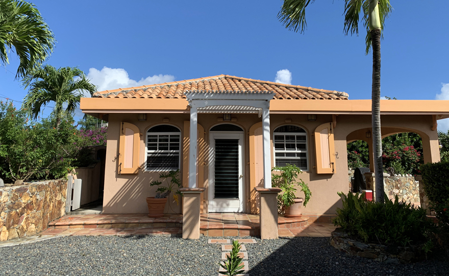 Cottage front door and gravel parking spot