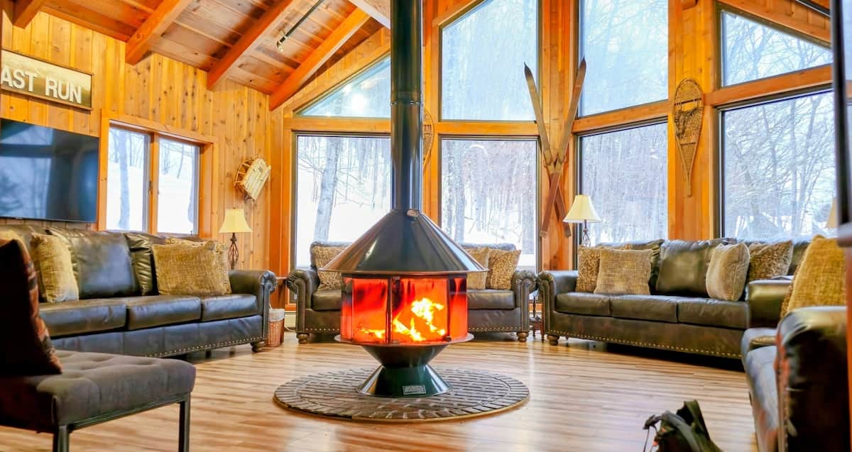 Cozy up by the fire in this charming Okemo Mountain Chalet, surrounded by winter's beauty!
