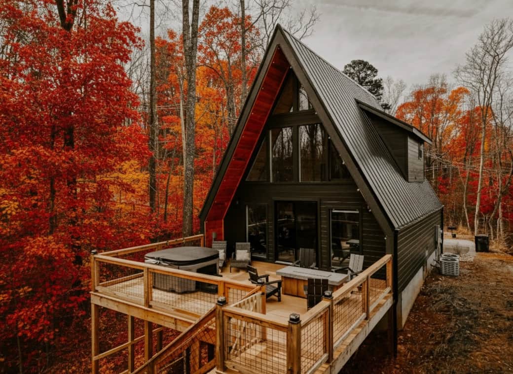 Relax on the back deck with cozy seating, a warm outdoor fireplace, and a private hot tub Relax on the back deck with cozy seating, a warm outdoor fireplace, and a private hot tub