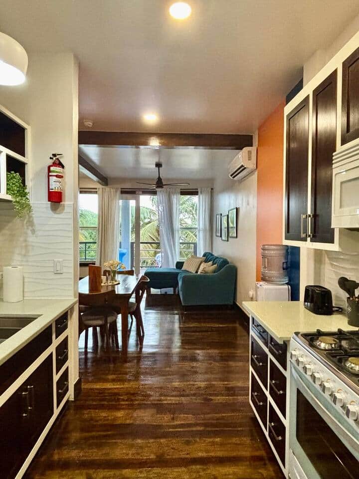 A charming one-bedroom suite with a fully stocked kitchen, stylish 4-seater dining table, and a cozy living room with plush seating—perfect for relaxing or entertaining after a day of exploring. A charming one-bedroom suite with a fully stocked kitchen, stylish 4-seater dining table, and a cozy living room with plush seating—perfect for relaxing or entertaining after a day of exploring.