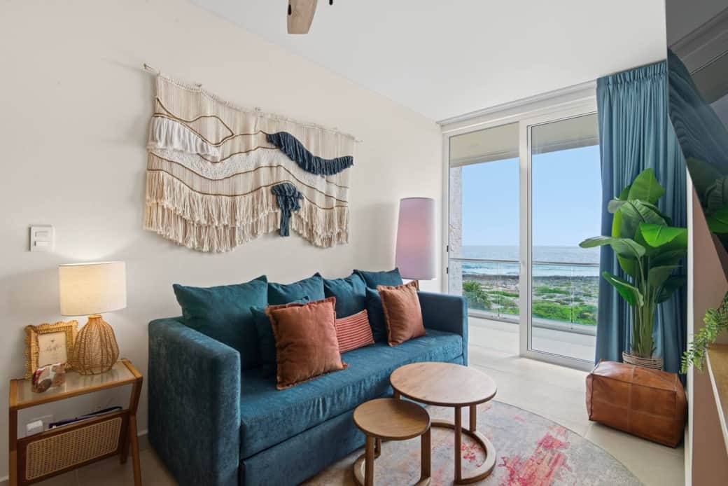 This inviting living room offers a sofa bed for two, a Smart TV with access to your favorite streaming services including Netflix, air conditioning, ceiling fan, and direct access to a private balcony to enjoy beautiful ocean views. This inviting living room offers a sofa bed for two, a Smart TV with access to your favorite streaming services including Netflix, air conditioning, ceiling fan, and direct access to a private balcony to enjoy beautiful ocean views.