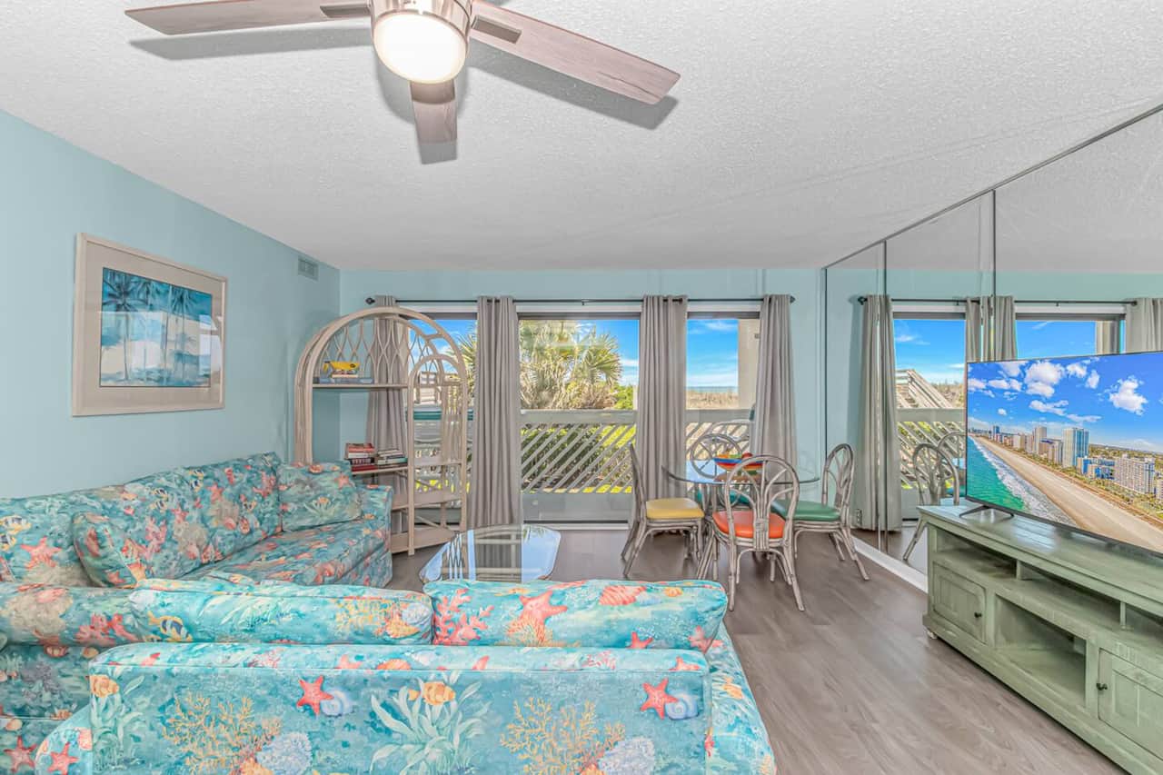 Bright coastal living room with ocean views and plenty of comfortable seating.
