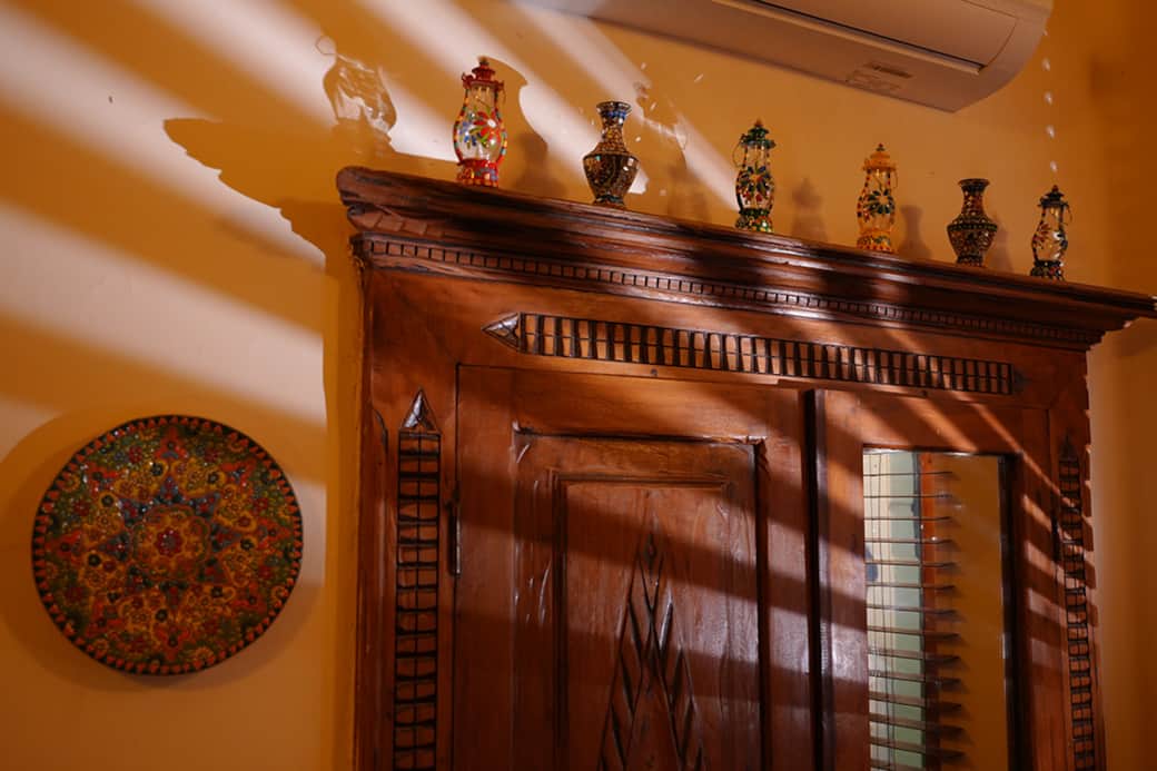 Shadows dance across handcrafted wood in the Saaya Suite