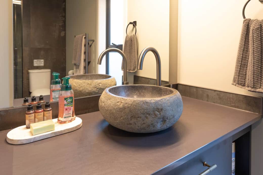 Master bathroom volcanic stone vessel sink.