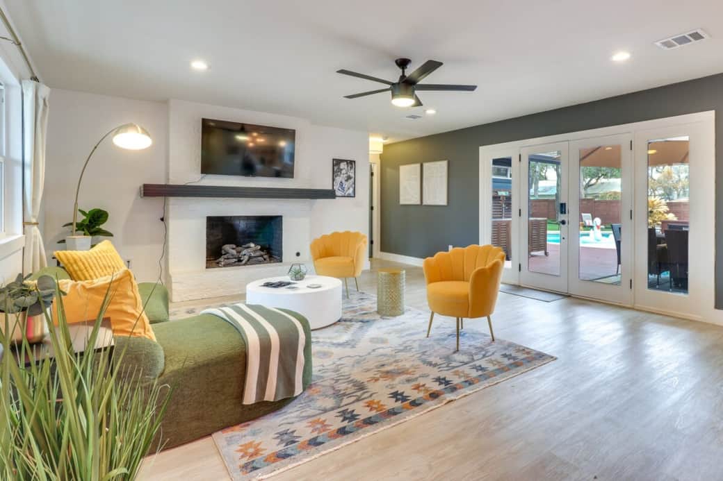 Bright, stylish living room with a cozy fireplace and seamless indoor–outdoor flow.