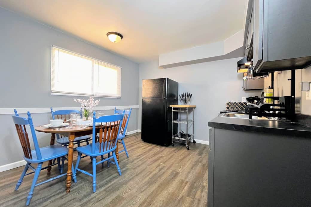 Rear kitchen and dining area have been outfitted with cookware and dinnerware