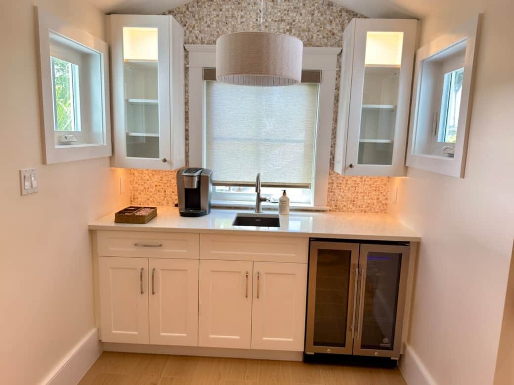 A convenient upstairs wet bar with a sink and wine cooler, tucked into the hallway between the bedrooms. Thoughtfully designed for easy refreshment and added comfort, it offers a practical touch for relaxing upstairs.