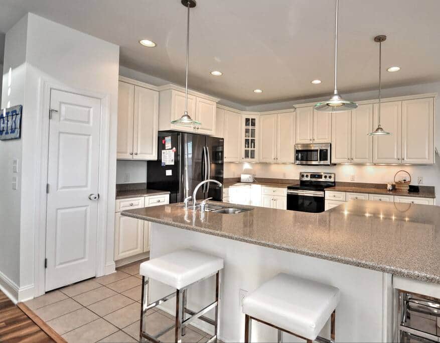 Kitchen with all-new Samsung appliances (refrigerator, stove/oven, microwave).
