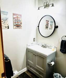 Full bath features shower and tub combo and new vanity