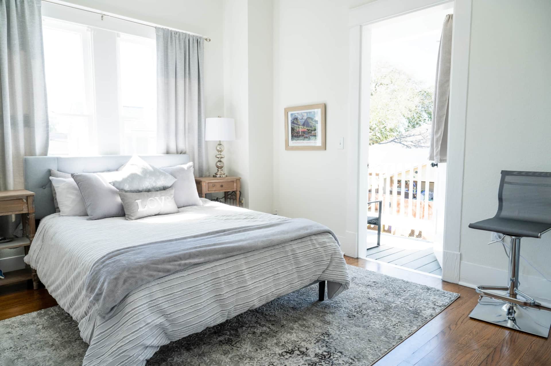 Primary queen bedroom with private balcony and blackout drapes.