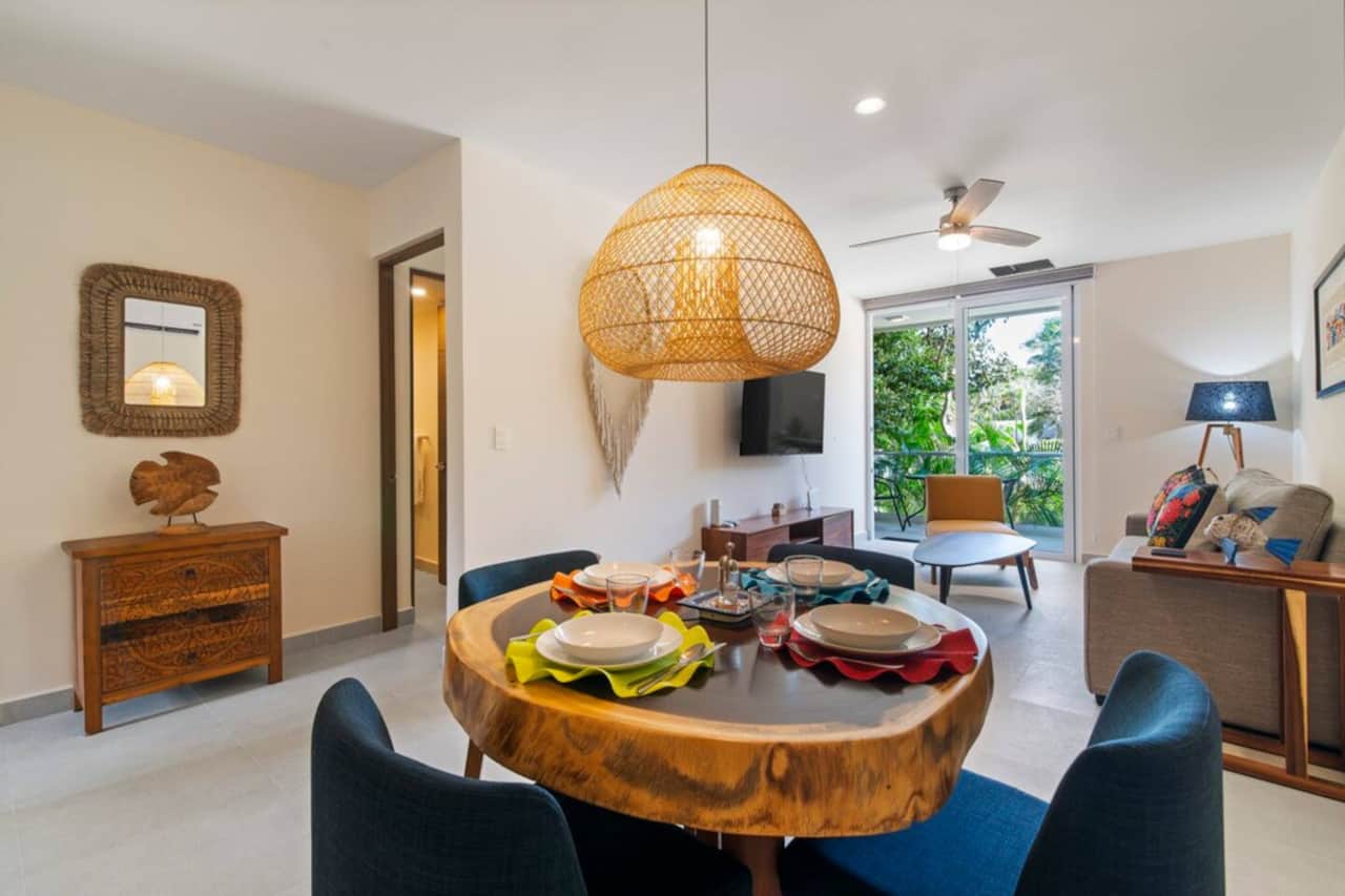 Cozy dining with a parota table for 4, AC, and full silverware.