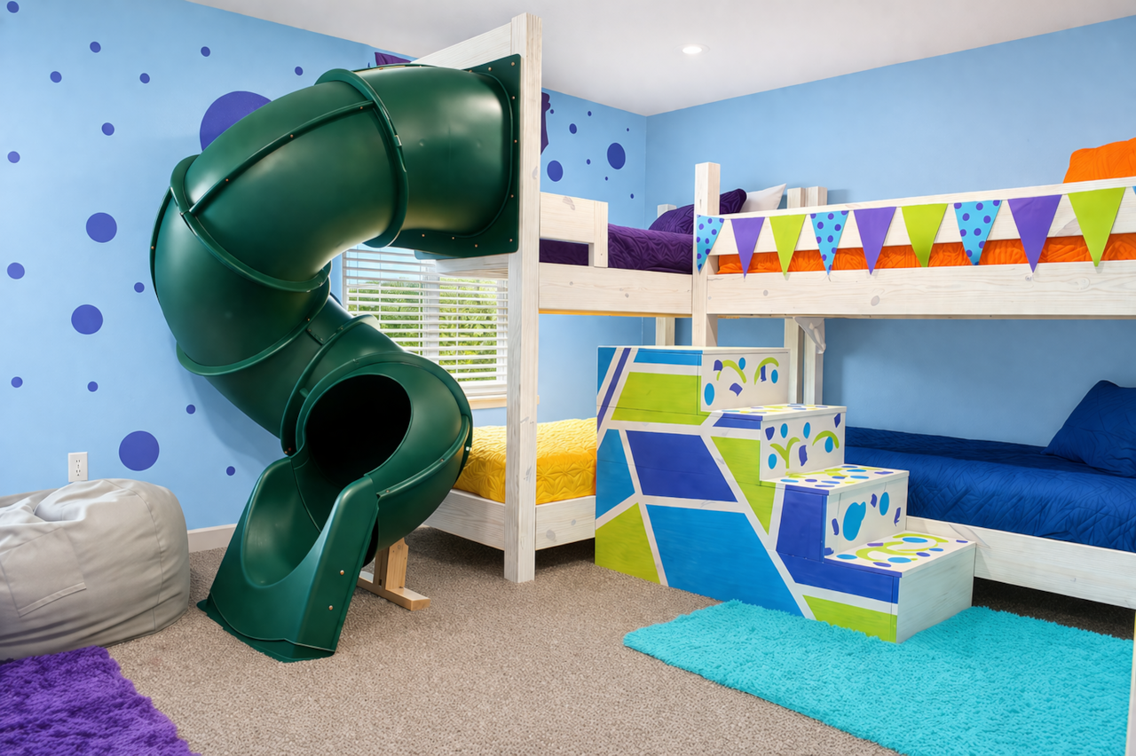 Kids' Adventure Room: Dive into excitement with a slide, vibrant bunks, and playful decor!