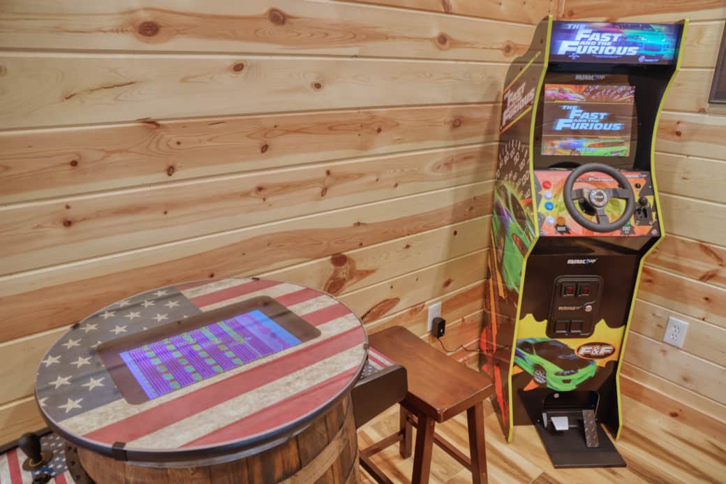 Gameroom with pool table, 43" FireTV, barrel arcade,  racing arcade, shuffleboard, & Connect Four.