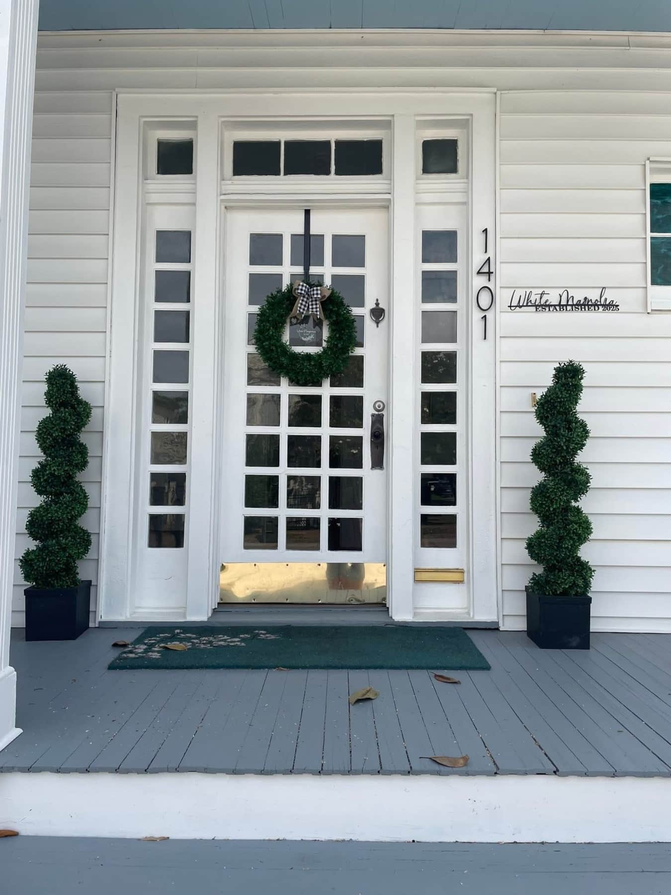 Front exterior of White Magnolia Galveston short-term rental in daylight, welcoming and well-styled