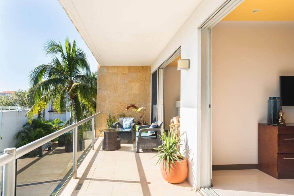 Balcony is accessible by large sliding doors from both the primary bedroom and the living room