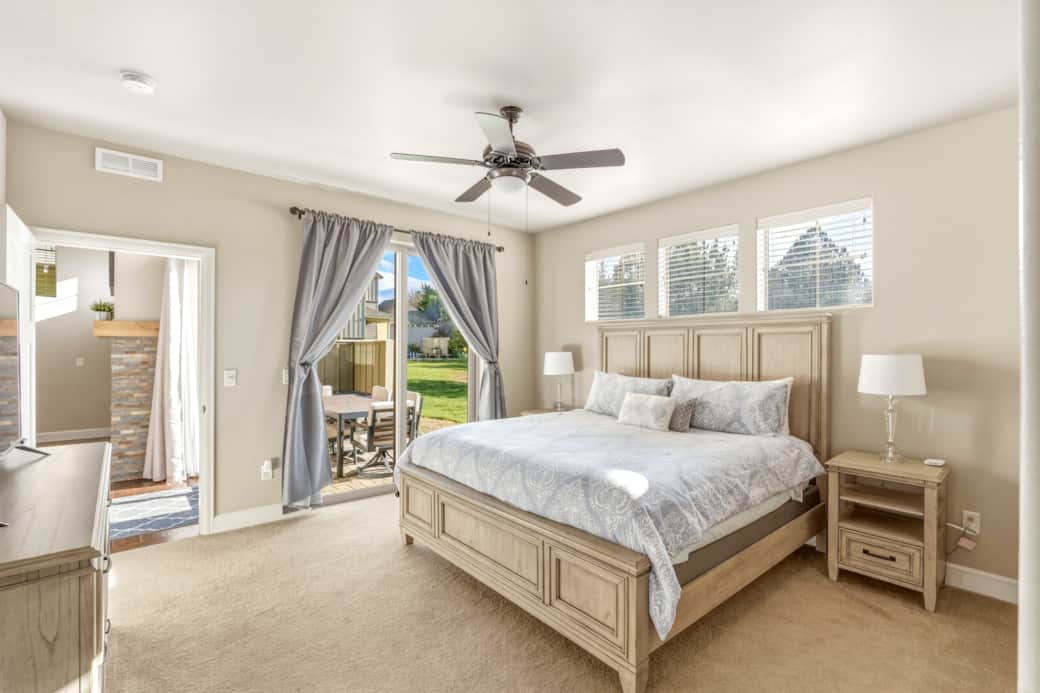 Main-floor king suite with slider to private patio and en-suite bath.