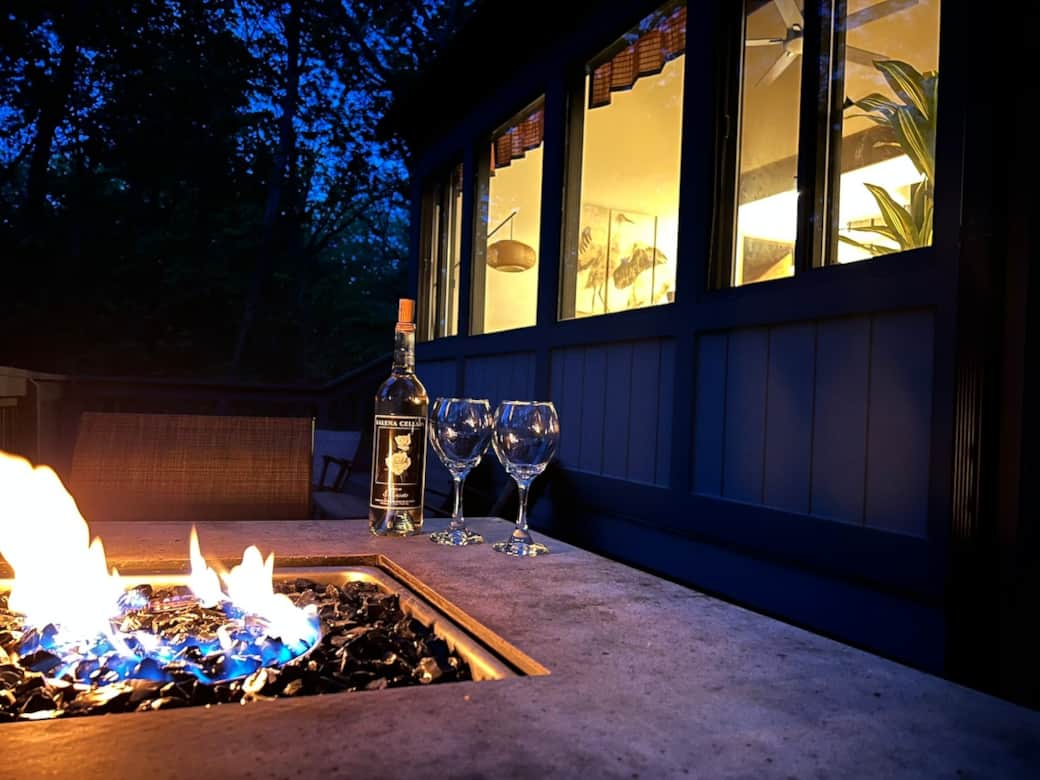 Back deck with extra seating, propane fire pit table, and Weber grill
