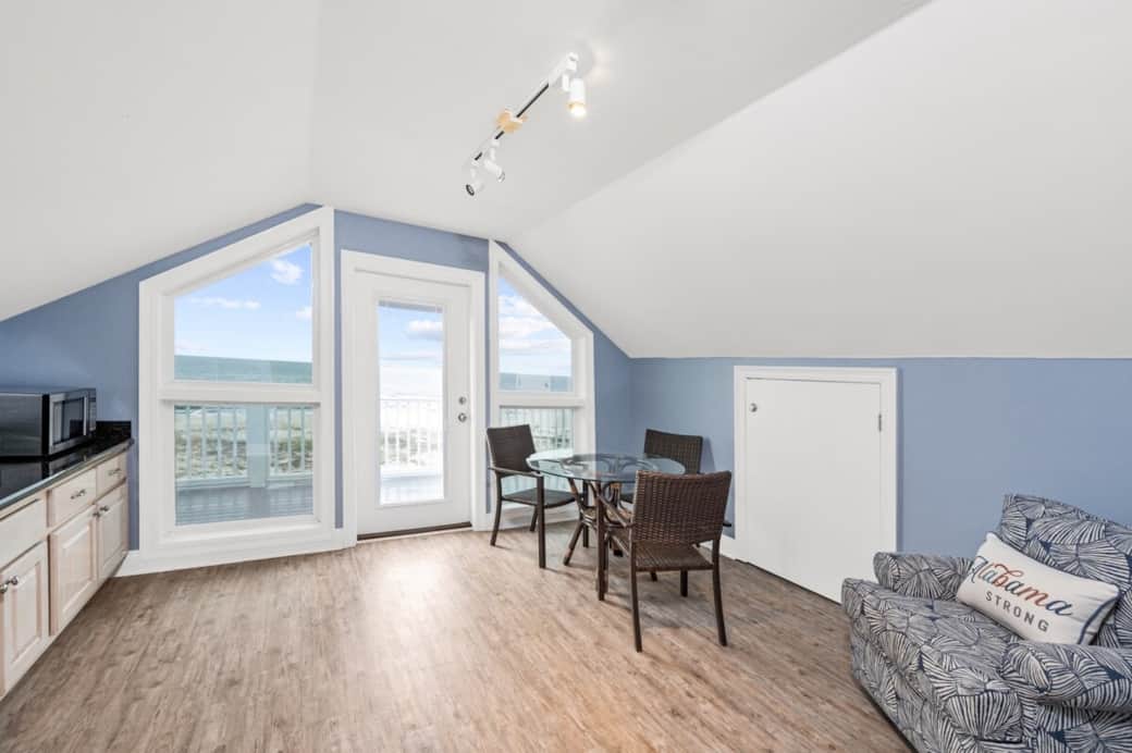 Master Bedroom Penthouse Suite Breakfast room with lounge chair, breakfast table, and the best view of the ocean.  There is a private walk out balcony for guests to enjoy the ocean view.  This is a perfect workspace for guests to use to take calls. 