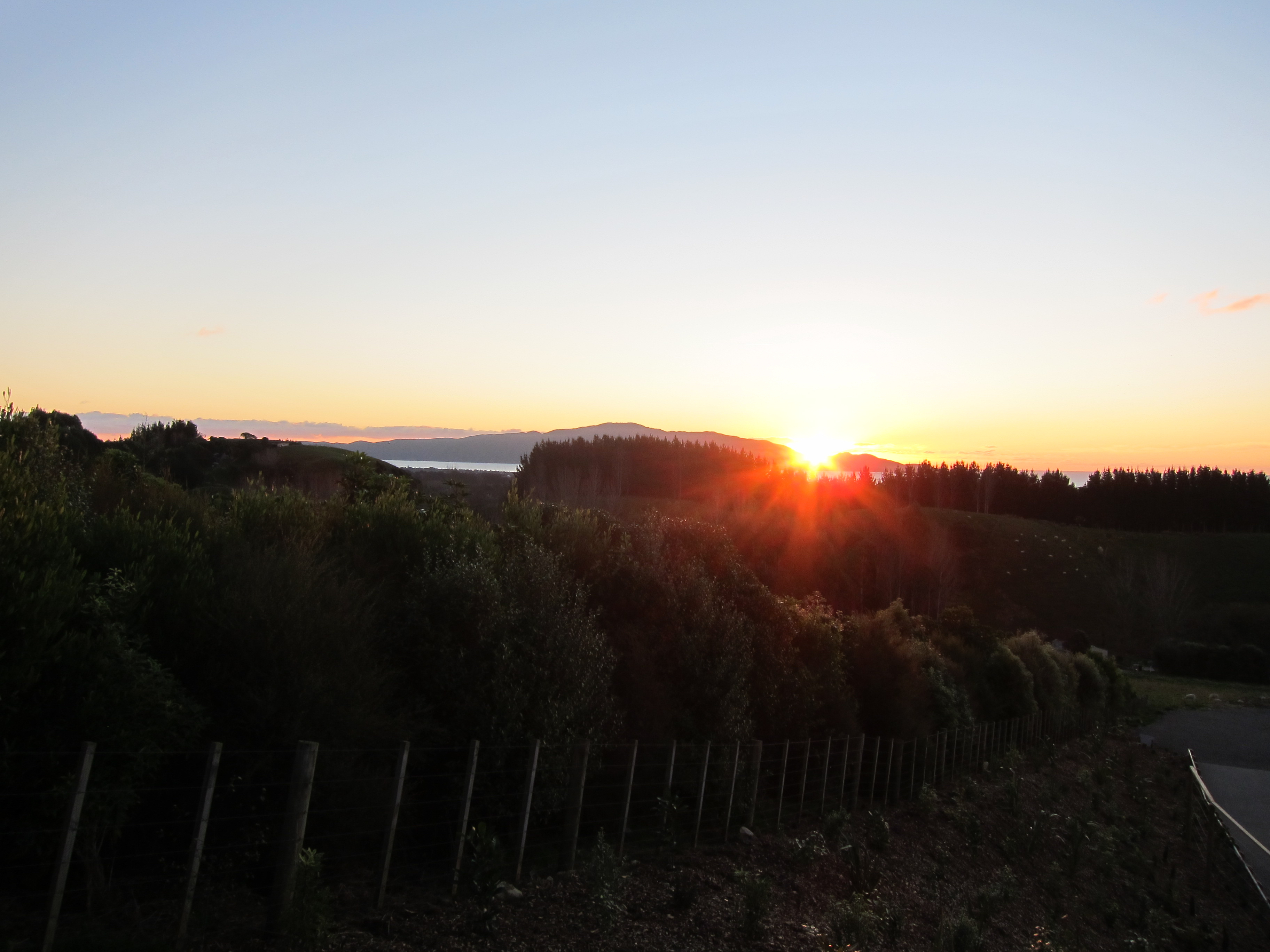Sun setting over Kapiti Island seen from Aston Road Villa.