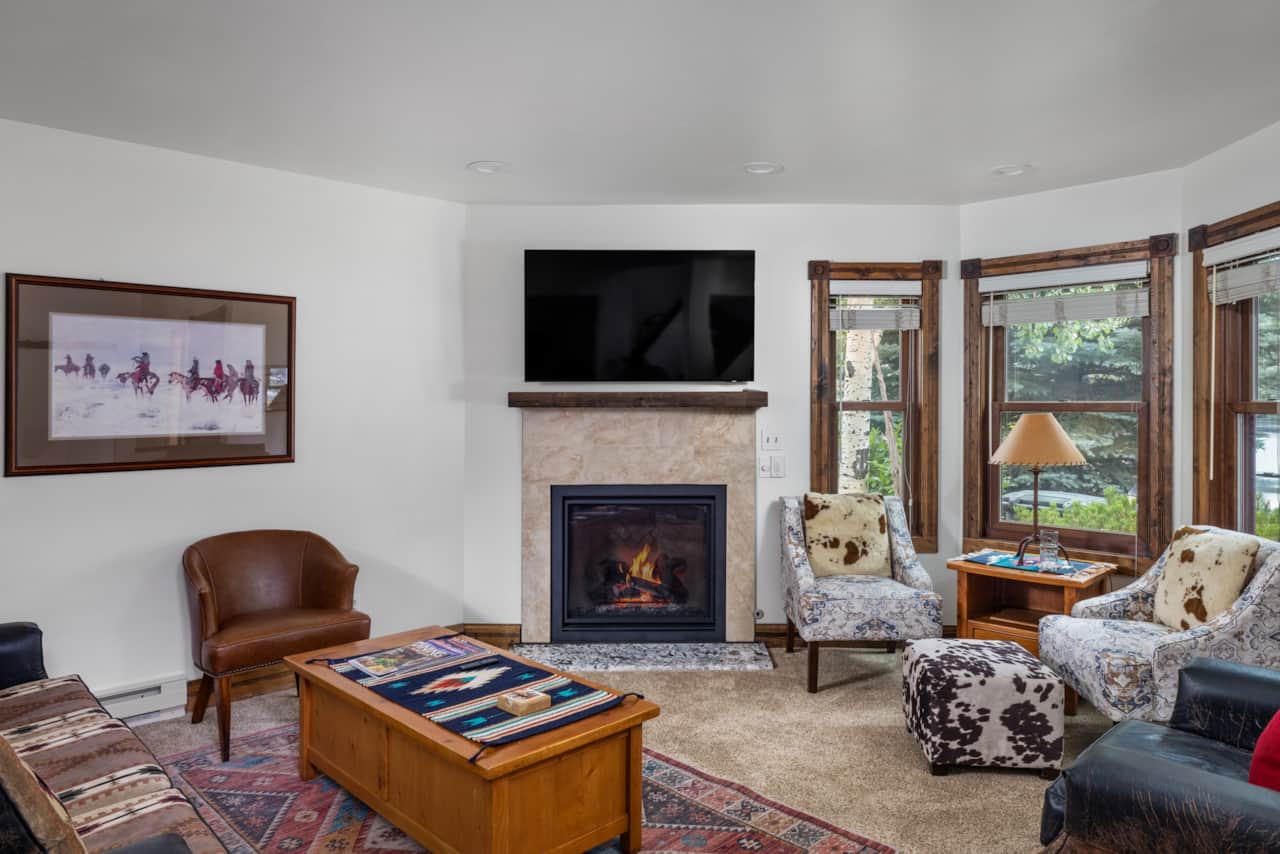 The living room features ample seating, flat screen TV and gas fireplace