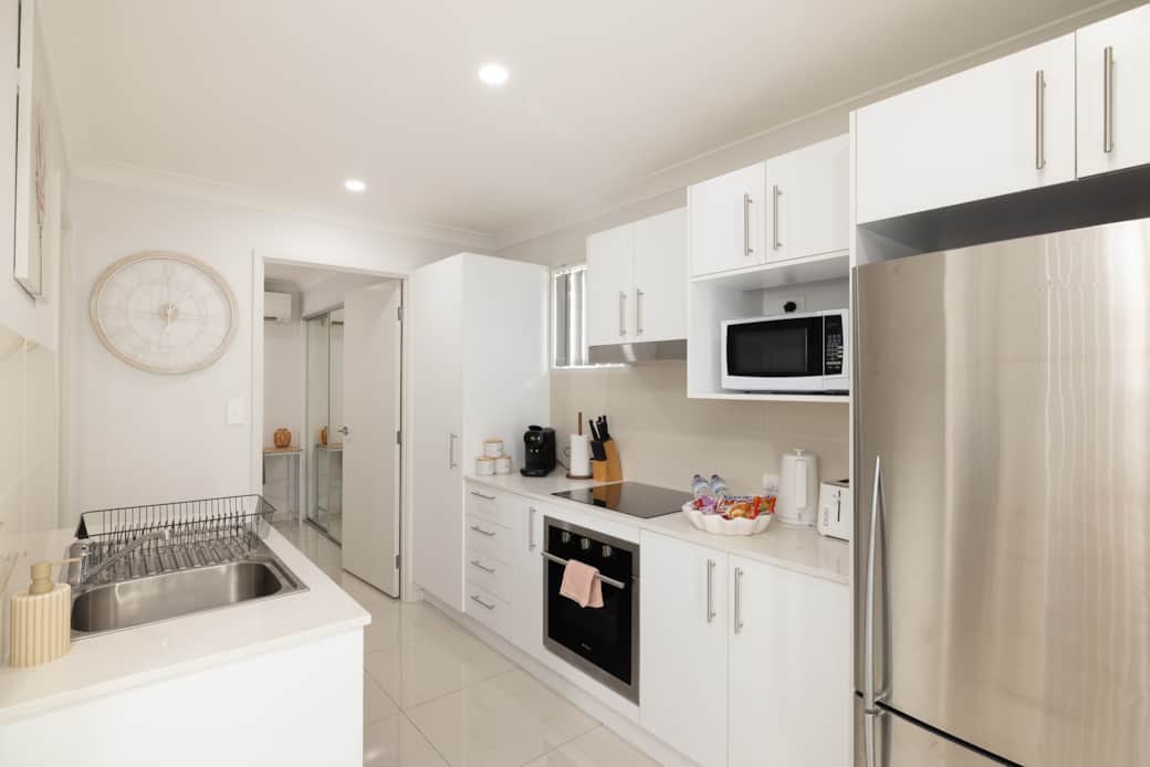 Kitchen: Sleek kitchen with ample storage, modern appliances 
