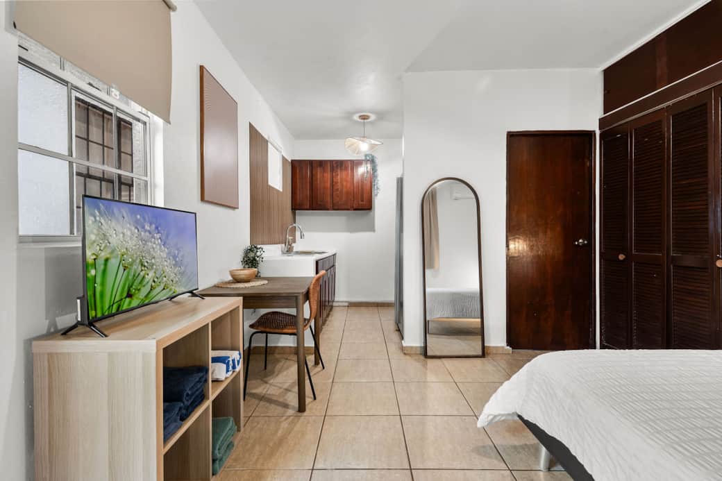 Open-concept studio with natural textures and dedicated dining space