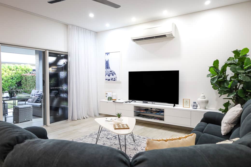 Stylish open living with plush seating, smart TV, and breezy flow to the outdoor patio.