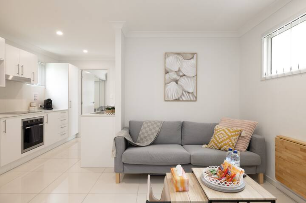 Living Area: Bright living space with comfortable seating and TV 