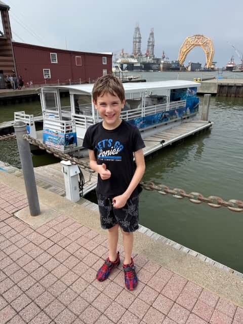 Mother and son enjoying a ferry ride adventure during their Galveston vacation