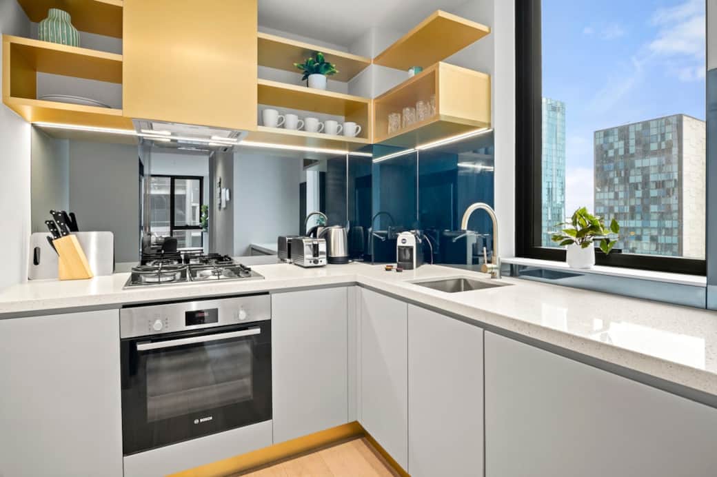 Sleek, contemporary kitchen featuring modern appliances, stylish finishes, and a bright window outlook — perfect for preparing meals with a view.