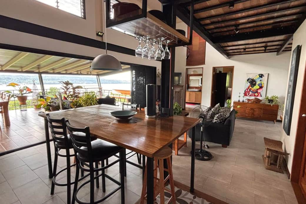 Screen doors can open for the loft-style main room and the large veranda overlooking the ocean to become one big interior/exterior living space. The main dining table is on the exterior veranda, with a smaller counter-style table in the Kitchen area. Screen doors can open for the loft-style main room and the large veranda overlooking the ocean to become one big interior/exterior living space. The main dining table is on the exterior veranda, with a smaller counter-style table in the Kitchen area.